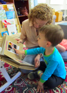 Student and teacher pointing at worm book