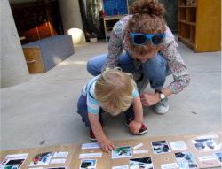 Teacher and toddler with worm book