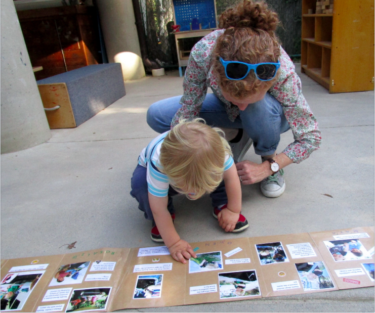 Teacher and toddler with worm book