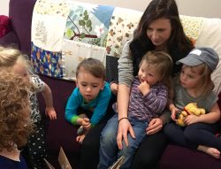 Teachers and young children reading worm book