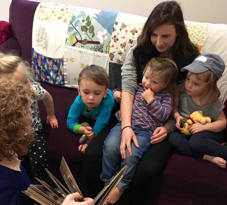 Teachers and young children reading worm book