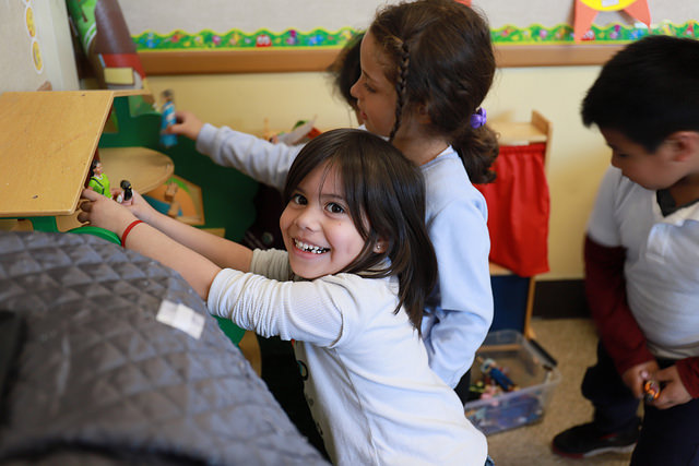 child smiling in classroom