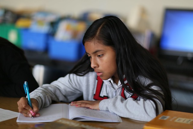 Student writing in notebook